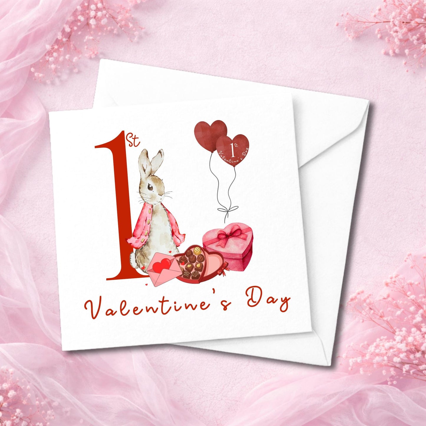 Cute baby’s first Valentine card showing bunny illustration beside red hearts and sweet gifts. Designed for new baby boys or girls. Printed on high-quality white cardstock with matching envelope. Displayed flat with chiffon fabric styling. Ideal for Etsy shoppers seeking unique keepsake Valentine’s cards for newborns or toddlers.